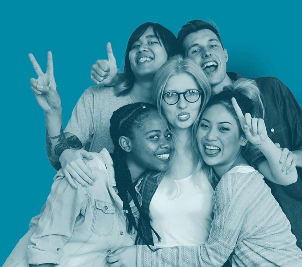 Group of young people of various ethnicities posing for a photo